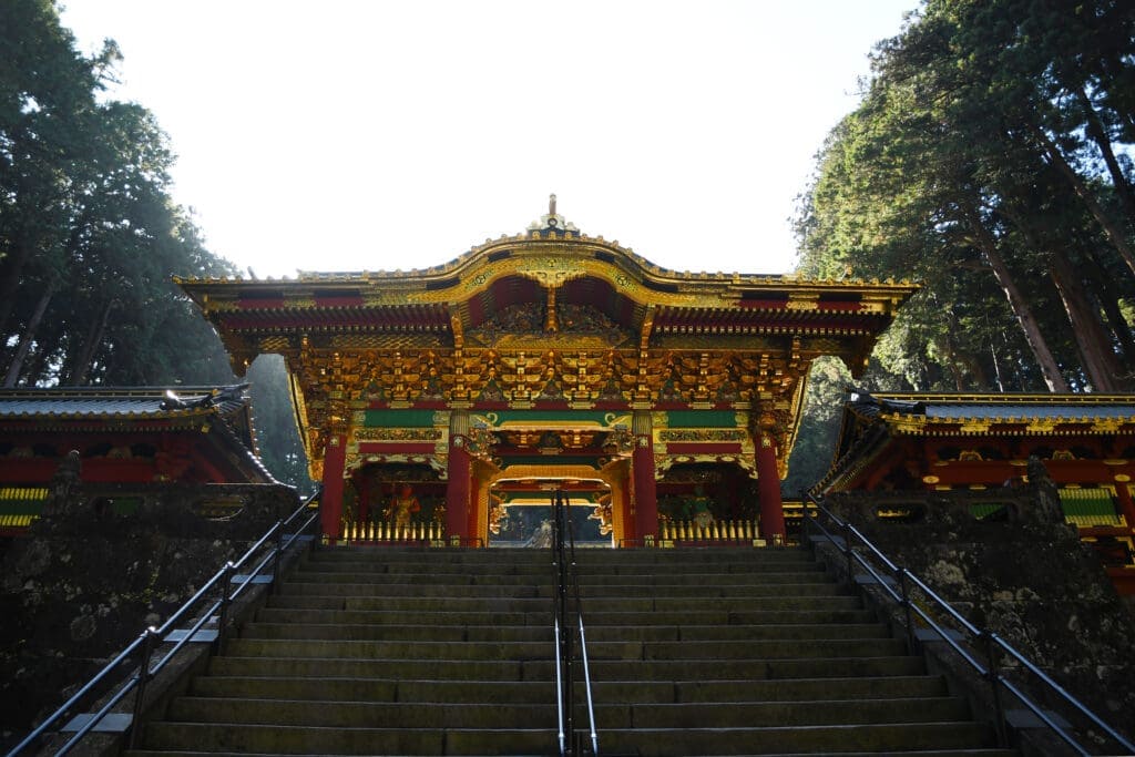 Nikko Toshogu Shrine, a red and gold shrine with stairs - a must visit when having a Nikko day trip from Tokyo