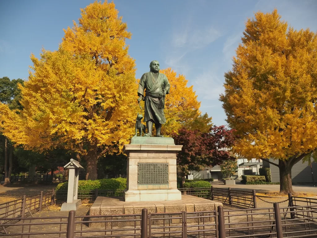 Statue in Ueno Park with Autumn Yellow Leaves