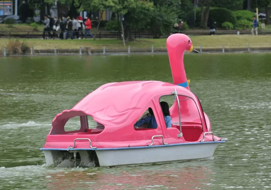 A pink dove water vehicle where people are enjoying the ride in Ueno, Tokyo